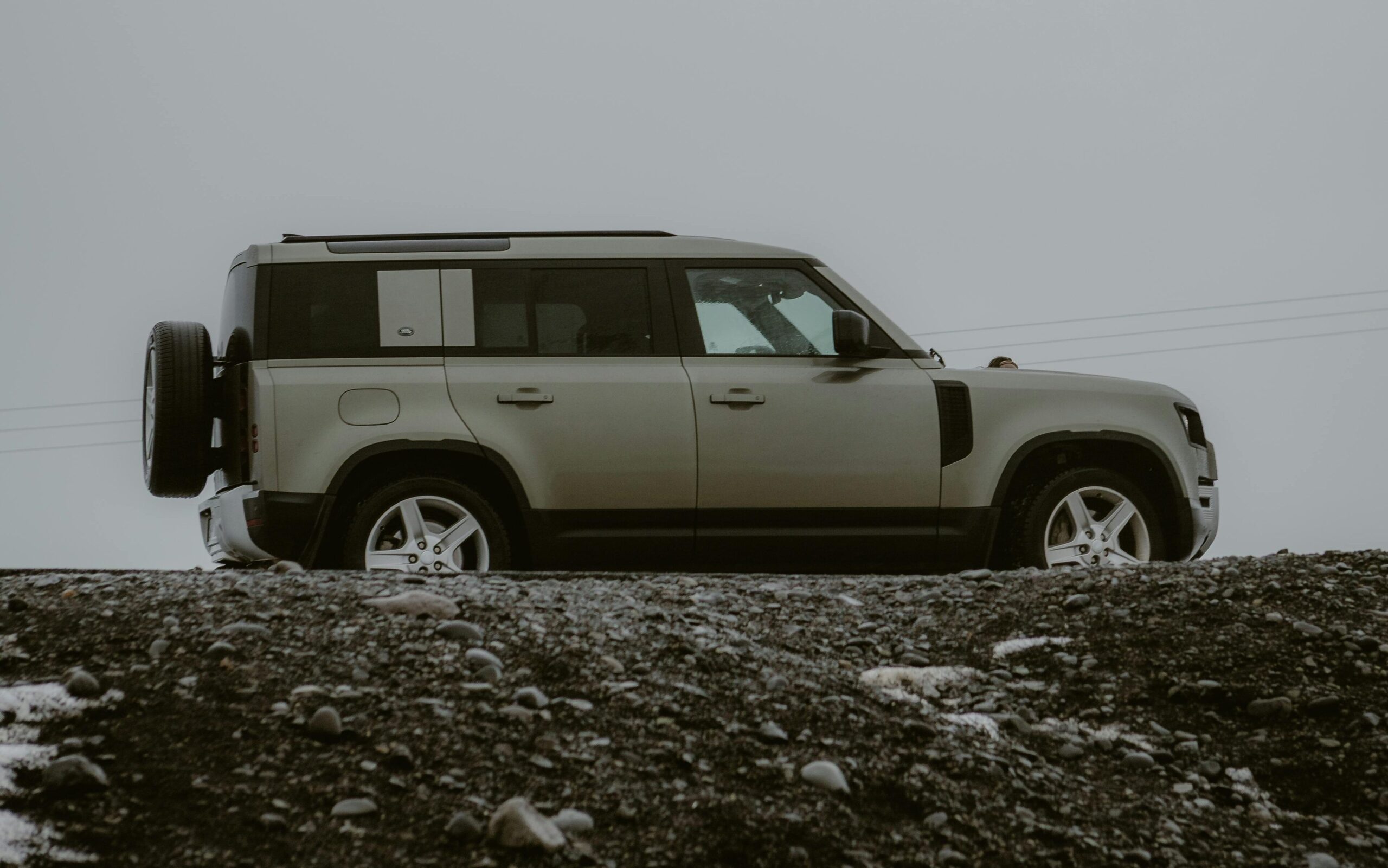 Explore rugged terrains with this SUV in a foggy setting. Perfect for adventure and travel enthusiasts.